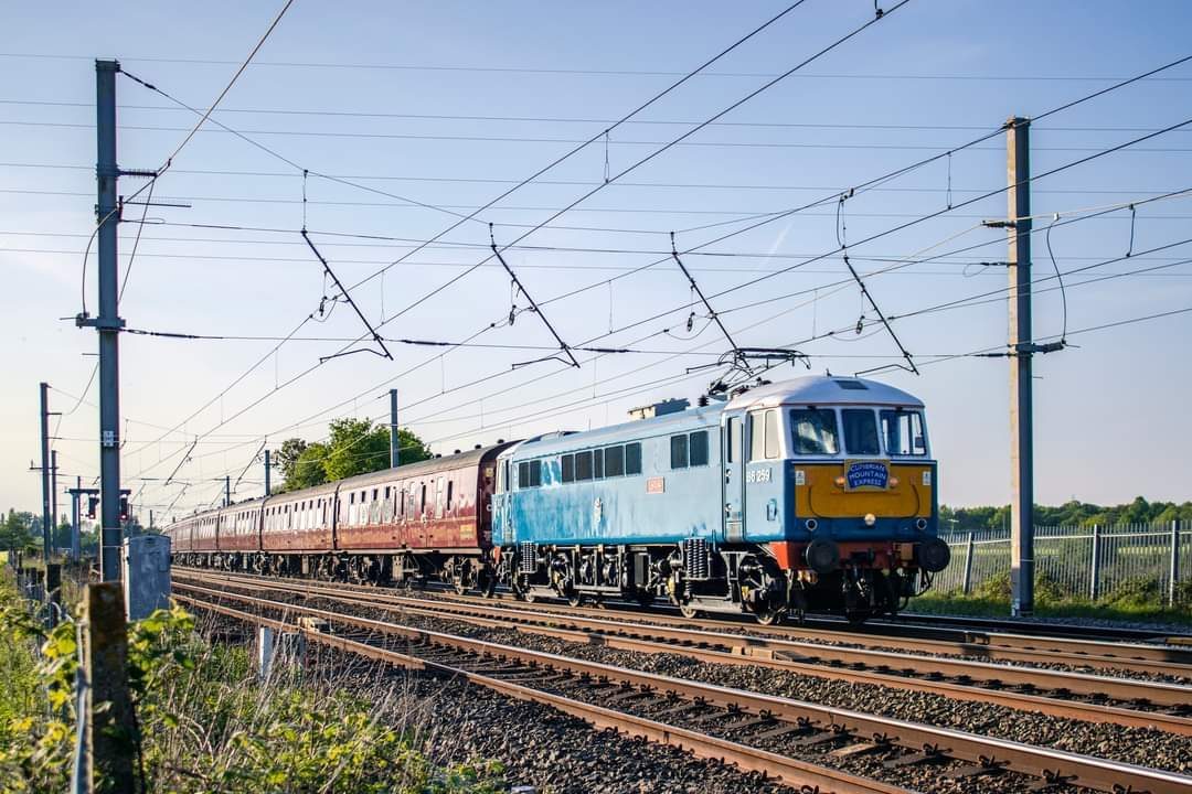 UK passenger train at a rural British station with traditional semaphore signals — train drivers must observe and respond to every signal type on the network